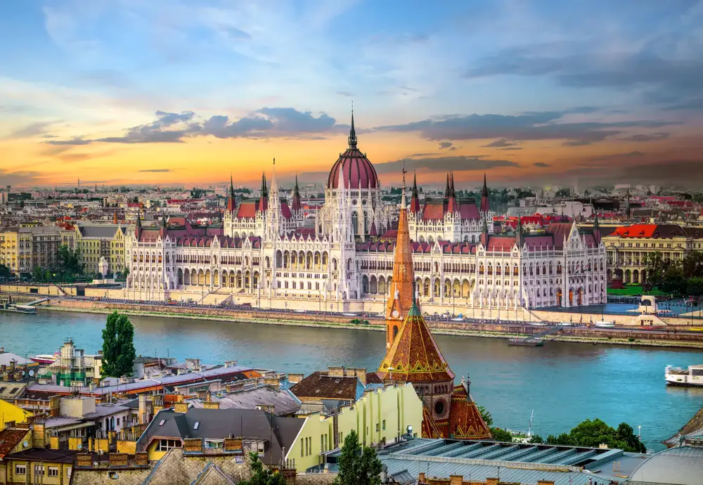 Hungarian Parliament beside the Danube in Budapest at sunset